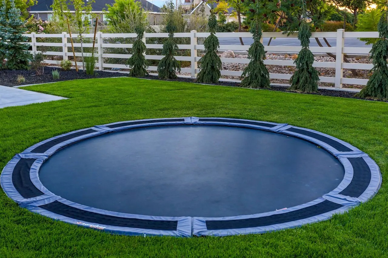 A round trampoline fitted in the grass