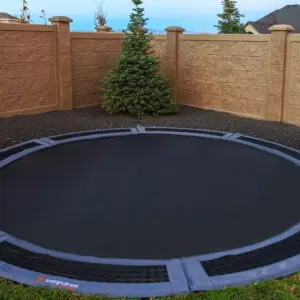 A huge black trampoline in the backyard