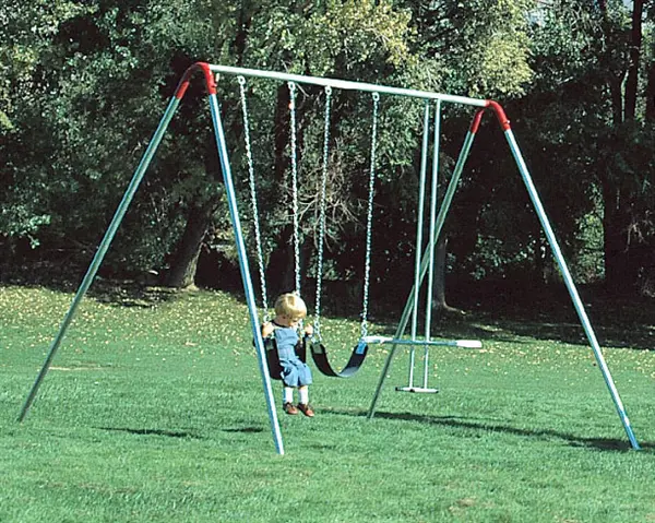 A small kid sitting on a frame swing with a glider